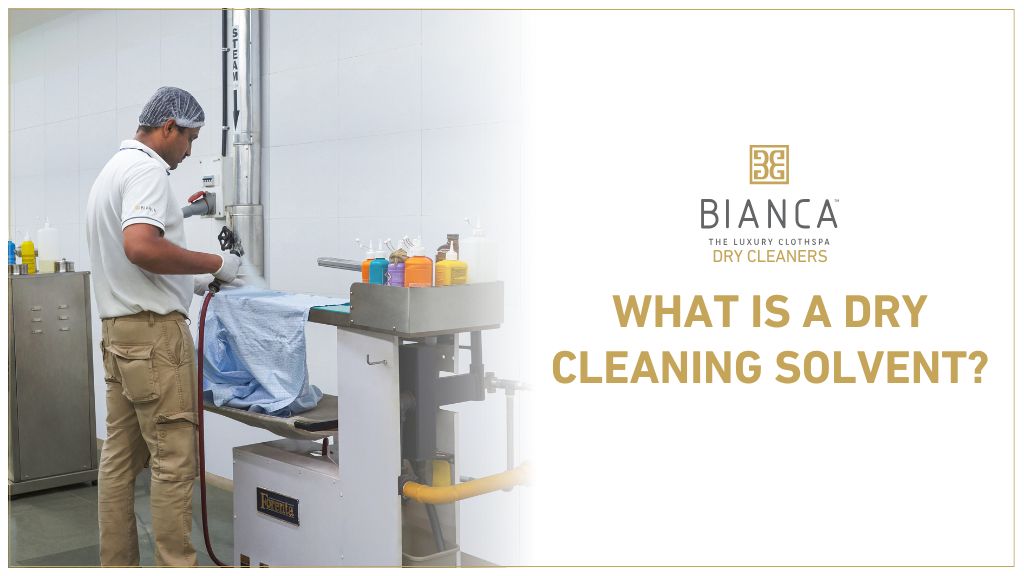 Technician using dry cleaning machine – understanding solvents used in Mumbai dry cleaning.