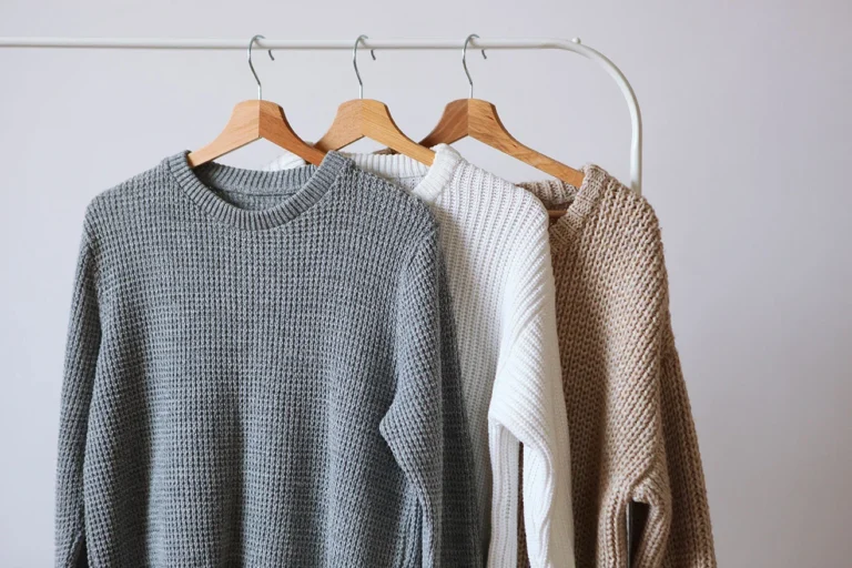Clean woolen sweaters on hangers – expert laundry services in Mumbai.