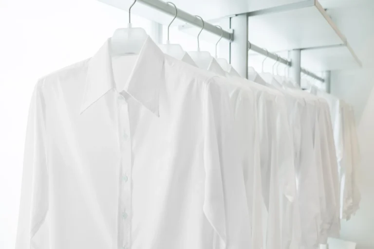 Crisp white shirts on hangers – premium laundry services in Mumbai.