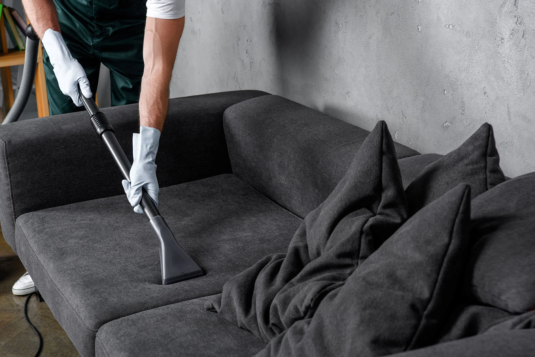 Professional cleaning dark sofa – on site upholstery cleaning service in Mumbai.