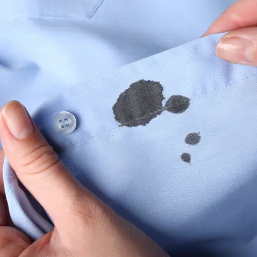 Ink stain on blue shirt collar before expert dry cleaning in Mumbai