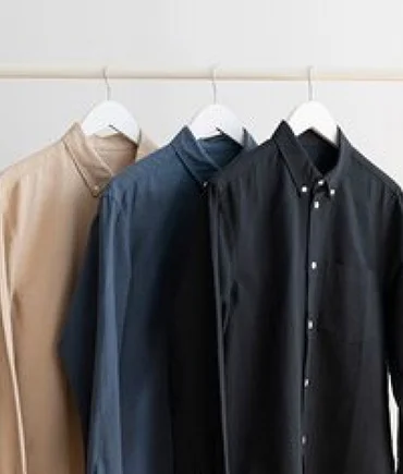 Formal shirts hanging on a rack, representing premium dry cleaning services in Mumbai