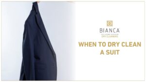 A navy suit with the text “When to Dry Clean a Suit” and the Bianca Dry Cleaners logo.