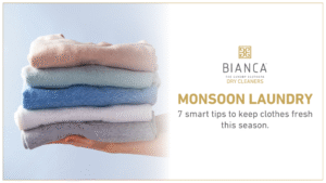 Hand holding folded clothes with laundry tips.